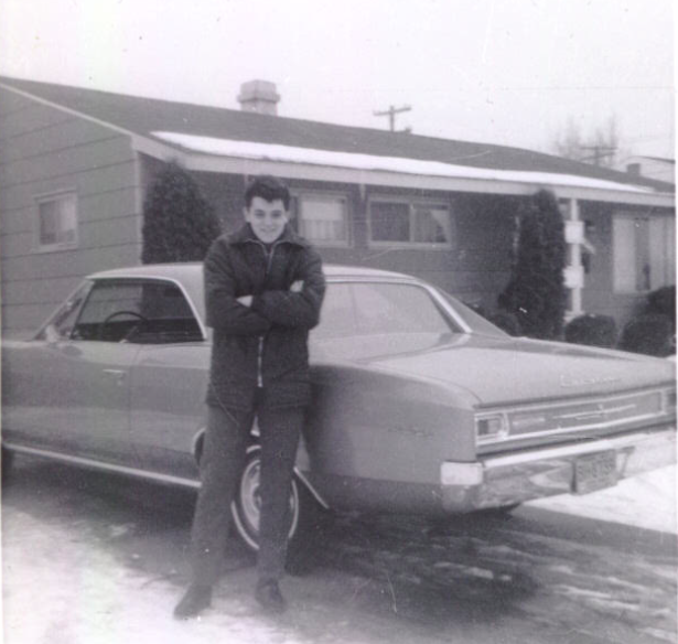 George poses in front of his uncle's car shortly after arriving in the United States.